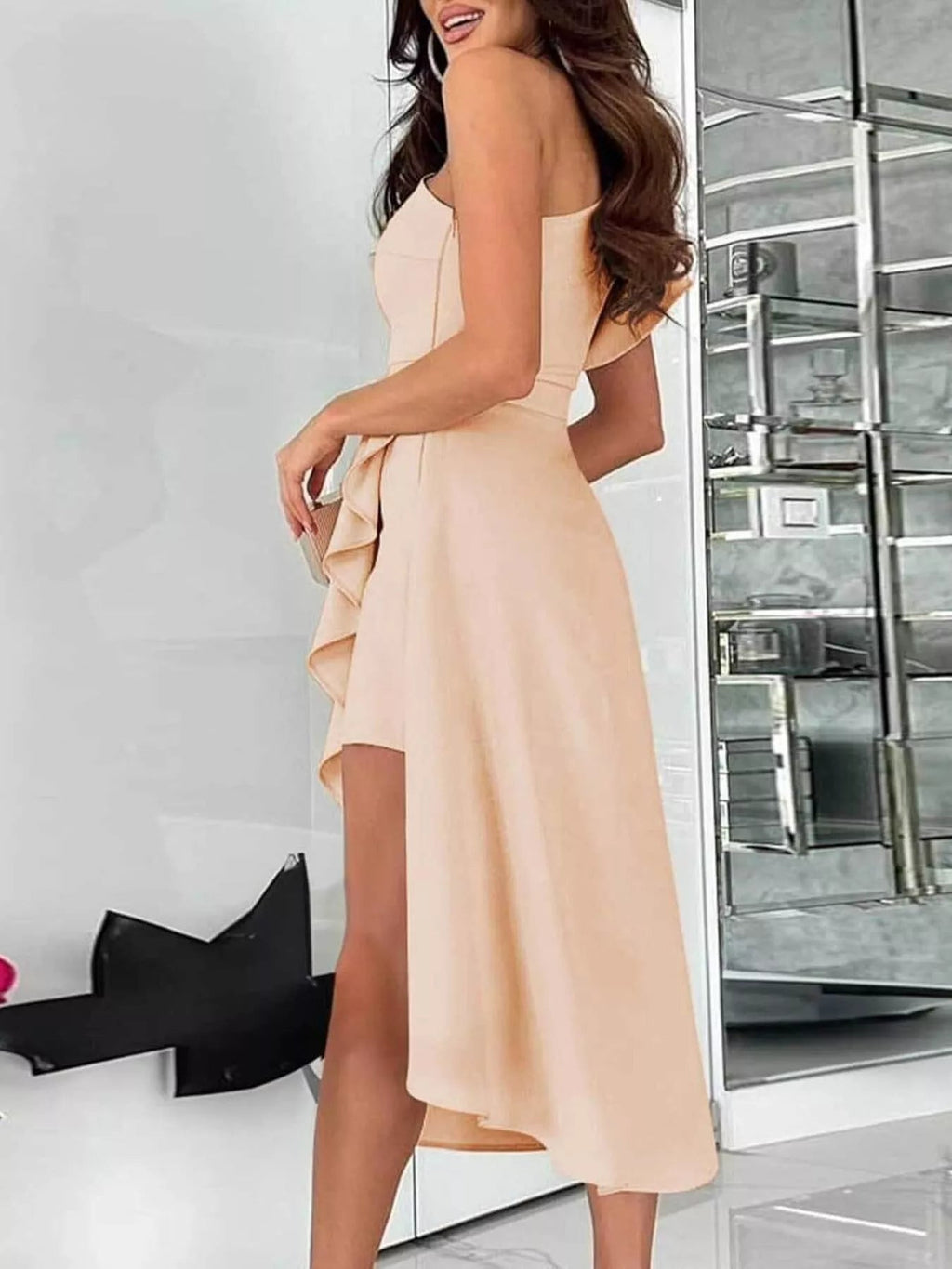 Side view showing the dramatic cascading high-low hemline of the elegant party dress