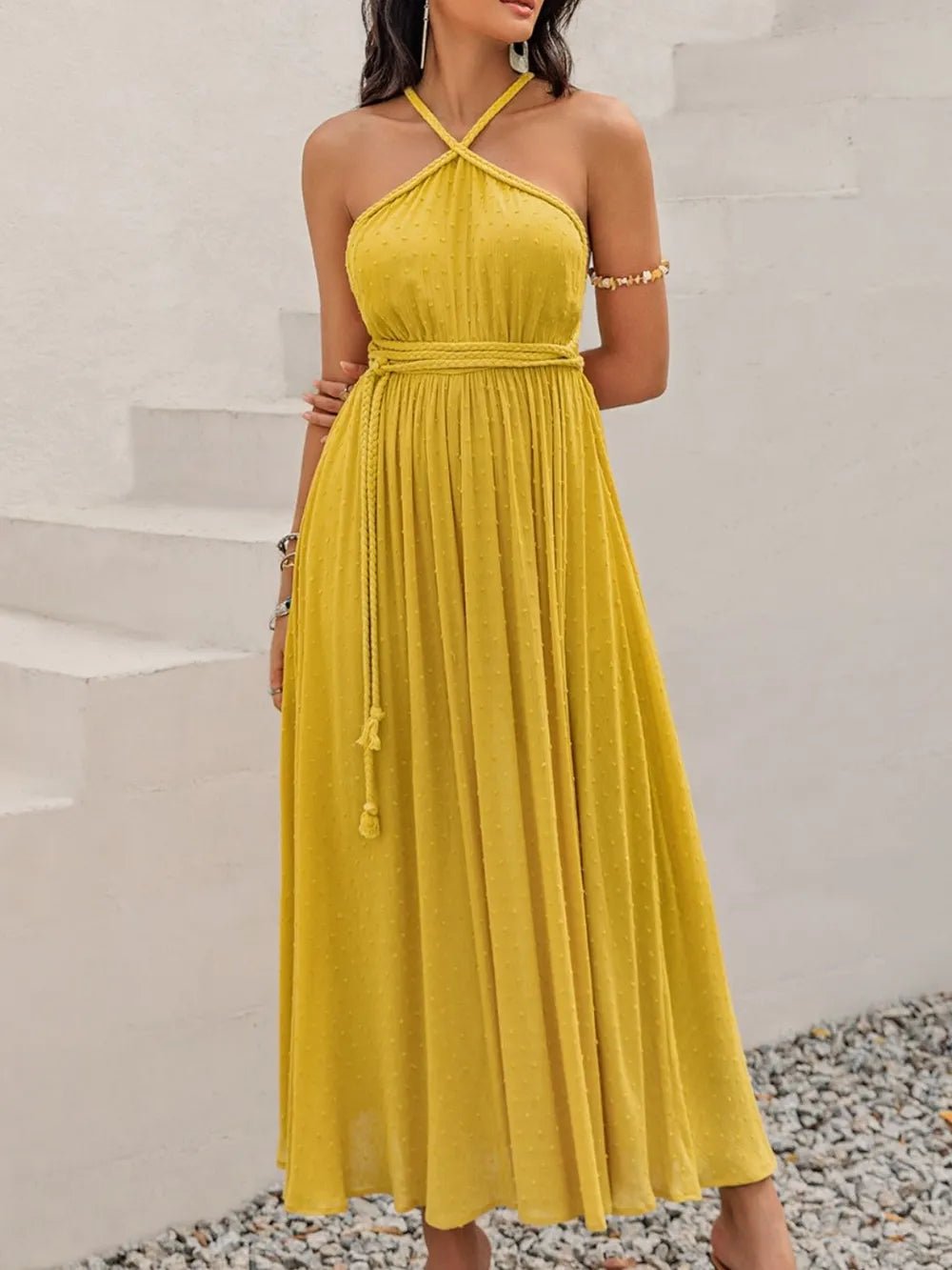 Model wearing a Mustard Yellow Swiss Dot Maxi Dress with halter neck - Heraki Summer Collection